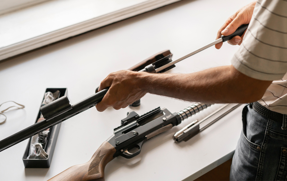 man cleaning a gun